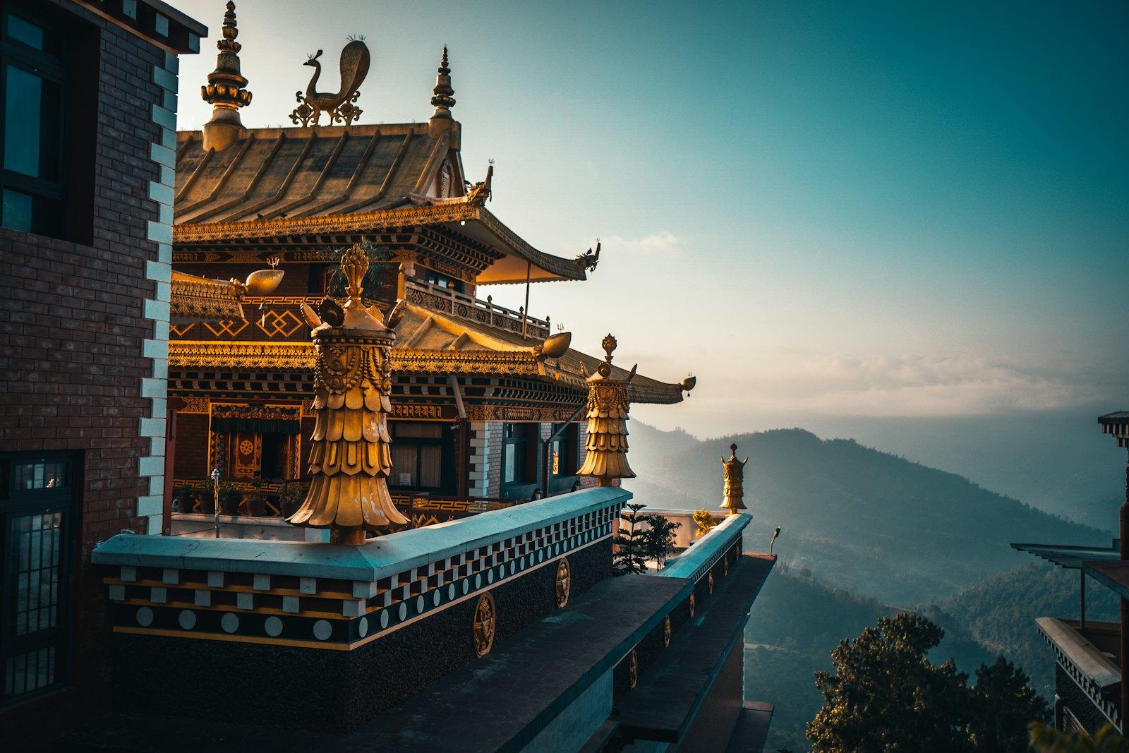 A golden monastery roof above misty ridges at dawn